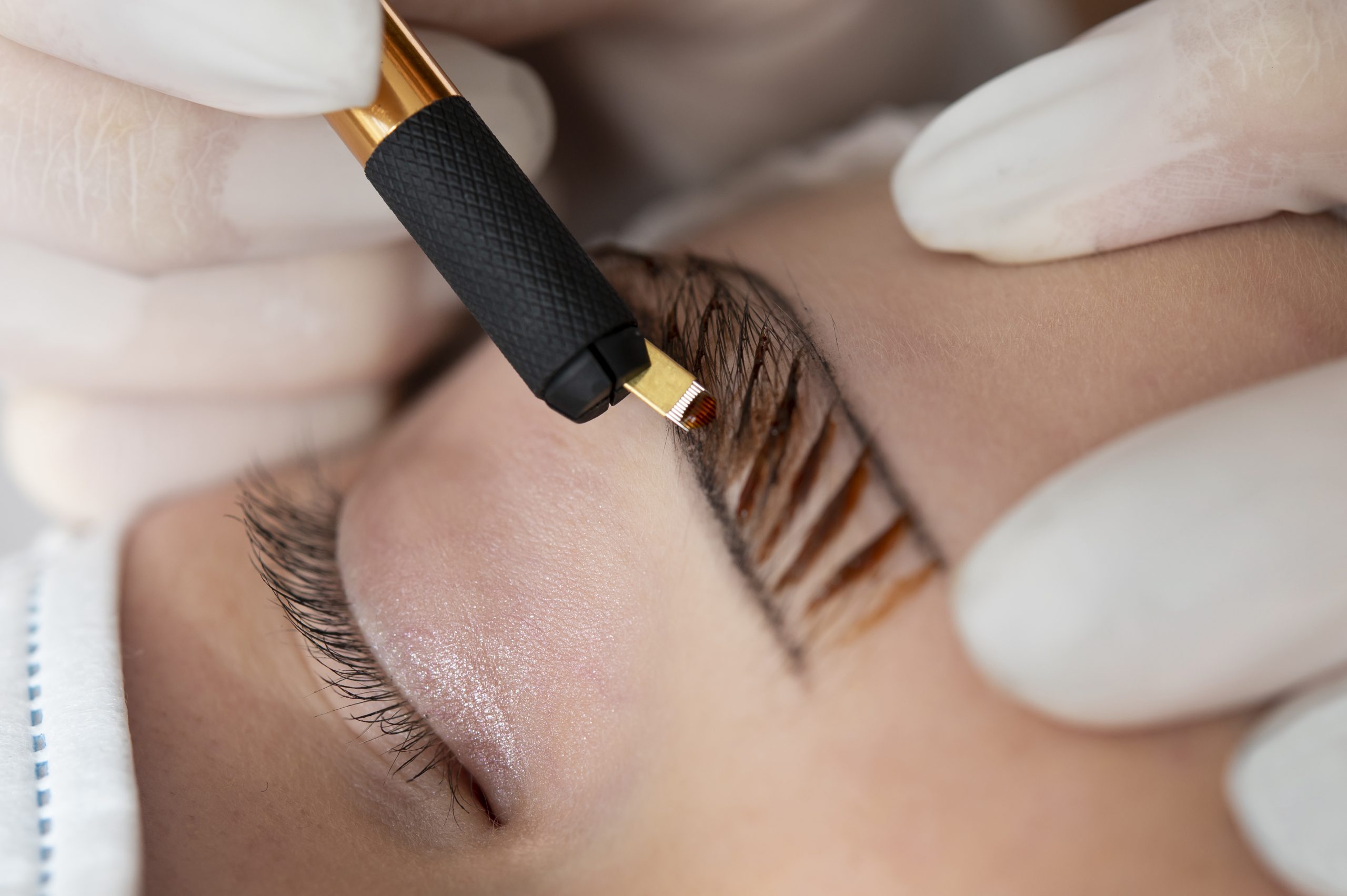 beautician-doing-microblading-procedure-on-client-s-eyebrows