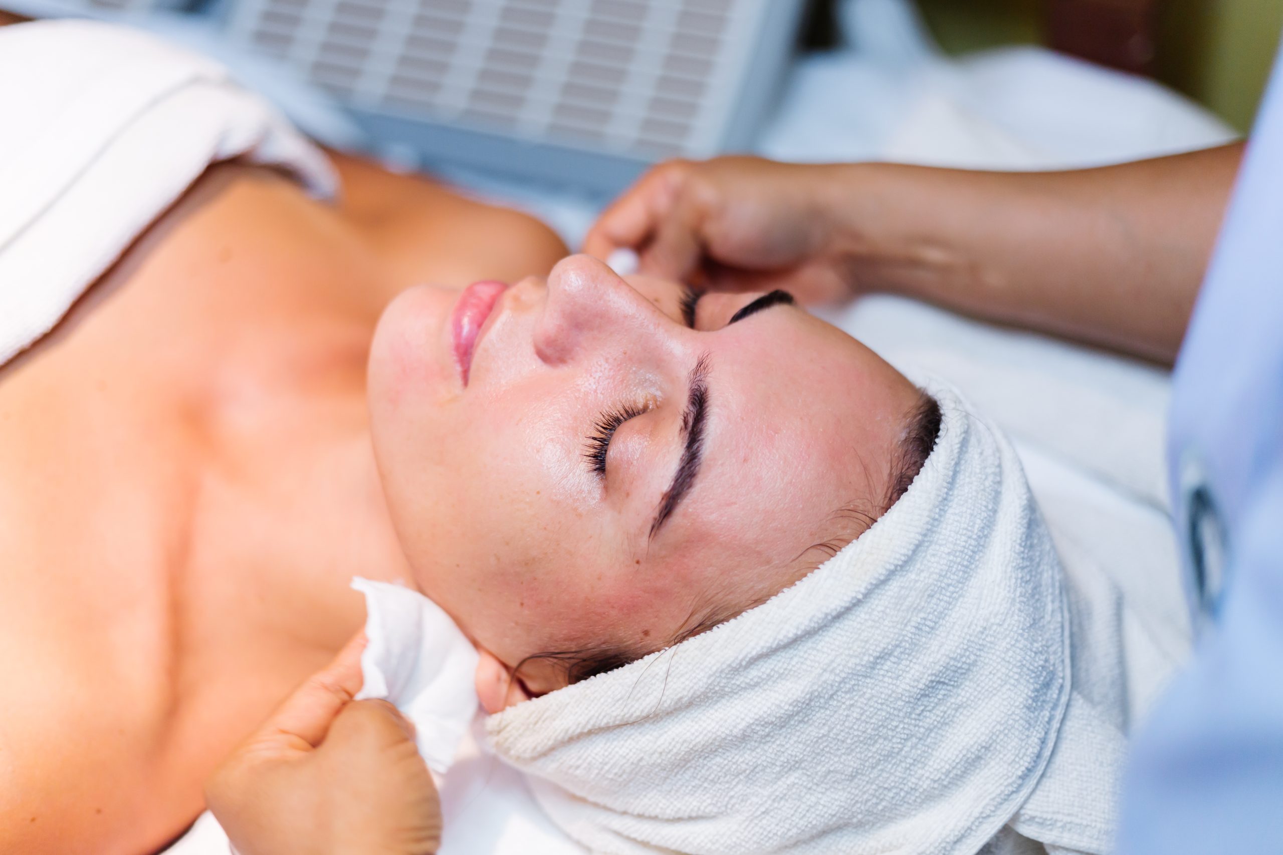 young-woman-lying-on-cosmetologist-s-table-during-rejuvenation-procedure